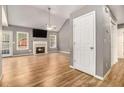 Spacious living room featuring vaulted ceilings, beautiful floors, fireplace, and natural light at 170 Double D Rd, Temple, GA 30179