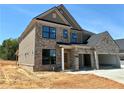 Two-story brick home with an attached two-car garage on a sunny day at 4190 Hosch Reserve Dr, Buford, GA 30519