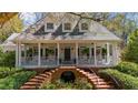Inviting two-story home with a large front porch, brick stairs and lush landscaping at 4635 High Point Rd, Atlanta, GA 30342