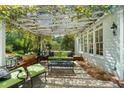 Charming outdoor patio space featuring a vine-covered pergola with string lights and comfortable seating at 4635 High Point Rd, Atlanta, GA 30342