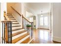 Beautiful foyer with hardwood floors, staircase, and white trim for a bright and airy feel at 570 Glengate Cv, Atlanta, GA 30328