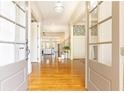 Inviting foyer with hardwood floors, elegant staircase, and views into the living spaces at 570 Glengate Cv, Atlanta, GA 30328