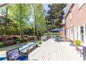Lovely white wooden deck and patio with lush landscaping for backyard entertaining and outdoor enjoyment at 825 Glengate Pl, Atlanta, GA 30328
