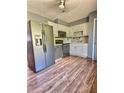 Functional kitchen with stainless steel appliances, white cabinets, and durable hardwood floors at 1320 Milstead Ne Ave, Conyers, GA 30012