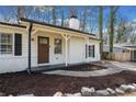 Close-up of a freshly painted home with a newly landscaped front entrance and refinished door at 181 Bridgewood Se Dr, Conyers, GA 30094