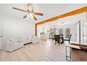 Open-concept living space with newly refinished floors connecting the kitchen and living spaces at 181 Bridgewood Se Dr, Conyers, GA 30094