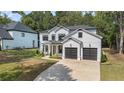 Stunning new construction featuring white siding, black trim, a two car garage and a well manicured lawn at 396 Academy St, Alpharetta, GA 30009