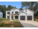 Beautiful two-story home with white siding, black trim, a 2-car garage, and well-manicured lawn at 396 Academy St, Alpharetta, GA 30009