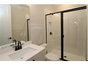 Modern bathroom with a glass-enclosed shower, white tile, and contemporary fixtures at 444 Lower Shoreline Ct Sw, Marietta, GA 30064