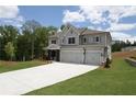 Attractive home with a spacious driveway, three-car garage, and beautifully landscaped yard at 444 Lower Shoreline Ct Sw, Marietta, GA 30064