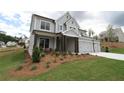 Charming two-story home featuring a three-car garage and lush front yard landscaping at 444 Lower Shoreline Ct Sw, Marietta, GA 30064