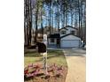 Charming two-story home with a mailbox and fresh landscaping in front yard at 5075 Forest Downs Ln, Atlanta, GA 30349