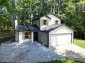 Charming two-story home features a classic design and a two-car garage at 5075 Forest Downs Ln, Atlanta, GA 30349
