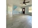Inviting living room featuring modern floors, neutral paint, and bright windows at 5075 Forest Downs Ln, Atlanta, GA 30349