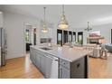 Bright kitchen view showcasing stainless appliances, a large island, and an open concept design at 6845 Wesley Hughes Rd, Cumming, GA 30040