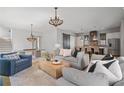 Open concept living room showcasing stylish chandeliers, modern furniture, and an inviting atmosphere at 6845 Wesley Hughes Rd, Cumming, GA 30040