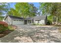 Charming single-story home with a wide driveway and an attached two-car garage at 10070 Timberstone Rd, Johns Creek, GA 30022