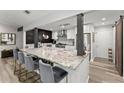Stylish kitchen with a large island, bar seating, granite countertops, stainless steel appliances, and modern decor at 10070 Timberstone Rd, Johns Creek, GA 30022