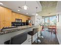 Modern kitchen with granite countertop bar open to the living space and city views at 860 Peachtree Ne St # 1511, Atlanta, GA 30308