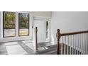 Bright foyer with wood-look flooring, stairs to upper level and exterior views at 5017 Tanaga Ct, Stone Mountain, GA 30087
