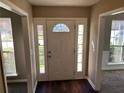 Inviting foyer featuring a white door with sidelights and transom window, and dark wood flooring at 5942 King Way Walk, Lithonia, GA 30058