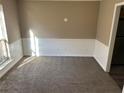 Bright living room featuring neutral paint, new carpet, white trim and large window at 5942 King Way Walk, Lithonia, GA 30058