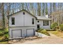 Inviting home with two-car garage, complemented by surrounding mature trees at 4141 Kalb Sw Ct, Smyrna, GA 30082