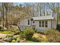 Two-story home with attached garage, surrounded by mature trees and landscaping at 4141 Kalb Sw Ct, Smyrna, GA 30082