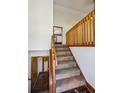 View of the carpeted staircase featuring wooden banisters and trim at 4141 Kalb Sw Ct, Smyrna, GA 30082