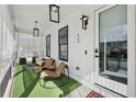 Inviting covered porch with stylish furniture and elegant black frame lighting at 969 Parsons Sw St, Atlanta, GA 30314