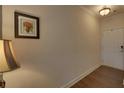 Welcoming hallway with hardwood floors, neutral paint, and ample lighting offers a warm entry at 5638 Maple Bluff Way, Hoschton, GA 30548