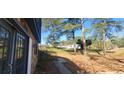 A stone walkway leading to a home entrance, surrounded by mature trees and a well-kept lawn at 1 Hidden Valley Dr, Lawrenceville, GA 30044