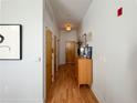 Hallway with light walls, hardwood floors, and wooden doors, accented by artwork and decor at 2630 Talley St # 426, Decatur, GA 30030