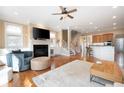 Open-concept living space with fireplace, hardwood floors, leading to a kitchen and staircase at 1020 Constitution Way, Cumming, GA 30040