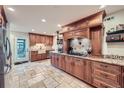Spacious kitchen with custom cabinets, granite countertops, stainless steel appliances, and tile floors at 1496 Leafmore Pl, Decatur, GA 30033