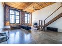 Open living room features exposed wood beams, a polished concrete floor, and large windows at 170 Boulevard Se # 421 H, Atlanta, GA 30312