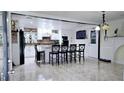 Modern kitchen with white cabinetry, granite countertops, a central island, and tile flooring at 3007 Hidden Dr, Lawrenceville, GA 30044