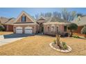 Charming one-story brick home featuring a two-car garage and well-manicured front lawn at 1913 Shenley Park Ln, Duluth, GA 30097
