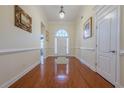 Inviting foyer with hardwood floors, arched doorway, and decorative lighting at 1913 Shenley Park Ln, Duluth, GA 30097