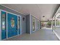 Inviting front porch featuring a turquoise front door, classic white railing, and neutral gray siding at 2000 Mcconnell Rd, Grayson, GA 30017