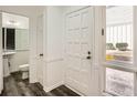 Bright entryway with white trim, a view of the bathroom, and a large front door at 2459 Cedar Canyon Se Ct, Marietta, GA 30067
