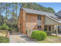Brick exterior featuring a carport, well-maintained lawn, and mature landscaping at 2459 Cedar Canyon Se Ct, Marietta, GA 30067