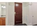 Welcoming entryway with dark wood door, marble floors and access to a half bathroom at 1717 N Decatur Ne Rd # 121, Atlanta, GA 30307