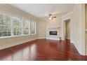 Bright living room features hardwood floors, a fireplace, and large windows at 1717 N Decatur Ne Rd # 121, Atlanta, GA 30307