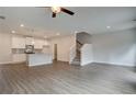Open-concept living room featuring wood-look flooring, recessed lighting, and staircase, perfect for entertaining and relaxation at 4544 Eastbrook Pl, Snellville, GA 30039