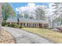Ranch home featuring a front porch with white columns and well manicured lawn at 3390 Somerset Sw Trl, Atlanta, GA 30331