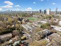 Aerial view of an apartment complex near a school and green fields, city in the background at 48 Peachtree Ne Ave # 412, Atlanta, GA 30305