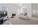 Bright, neutral living room with fireplace, plush carpet, and lots of natural light at 6450 Wellington Chase Ct, Lithonia, GA 30058