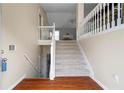 Inviting entryway with wood floors and staircase leading to the upper level of the home at 174 Whetstone Way, Villa Rica, GA 30180