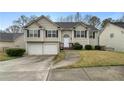 Charming split-level home with manicured lawn, two-car garage, and inviting front porch at 174 Whetstone Way, Villa Rica, GA 30180